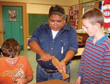Carving culture: A Sliammon elder shows how to carve traditional paddles.